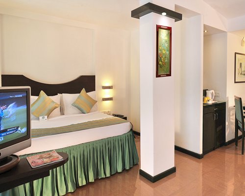 A well furnished bedroom with a television.
