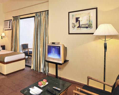 A well furnished bedroom with a television.