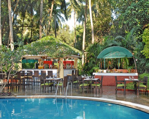 An outdoor fine dining area alongside the swimming pool.