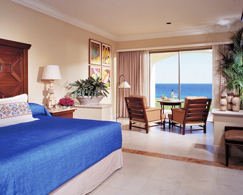 An open plan bedroom and dining area with a patio.