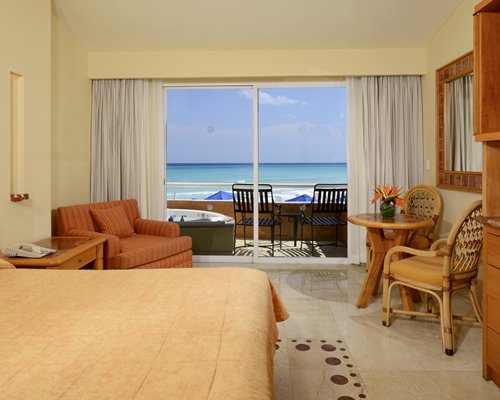 An open plan bedroom living room with balcony.