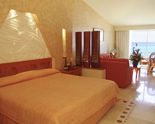 A well furnished bedroom with the beach view.