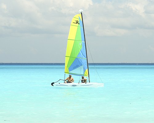 View of people in a sailboat on the sea.