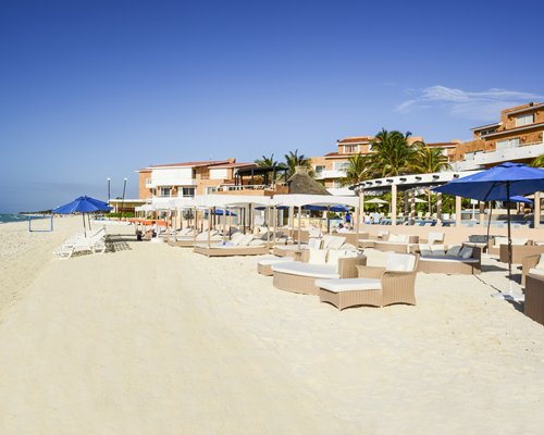 View of cabanas and sunshades facing the sea alongside the resort.
