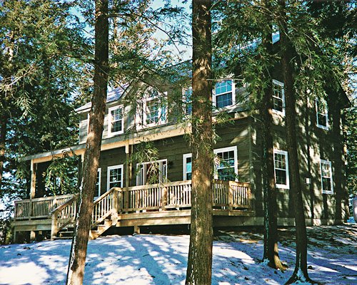 An exterior view of a resort unit alongside trees.