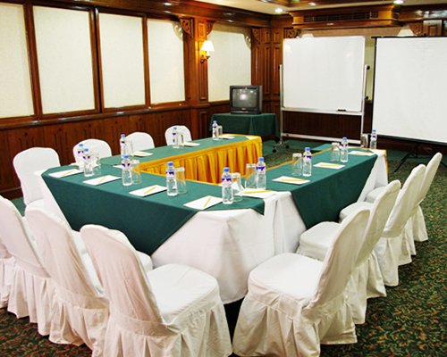 A well furnished conference hall with a television.