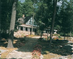 Scenic pathway to Chaudiere Lodge surrounded by wooded area.