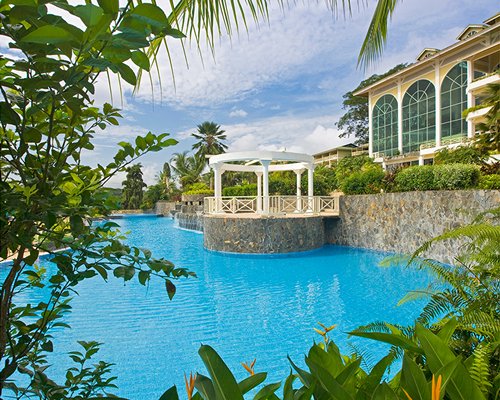 An exterior view of an outdoor swimming pool alongside the resort.