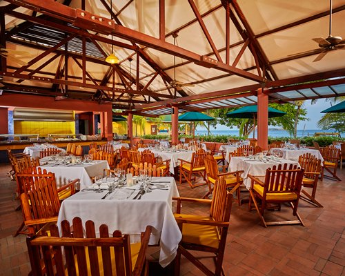 An indoor fine dining area at the resort with the beach view.