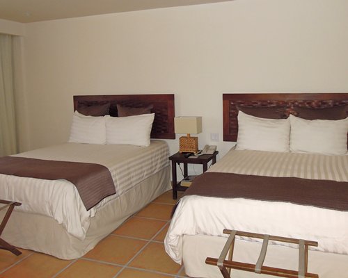 A well furnished bedroom with two beds.