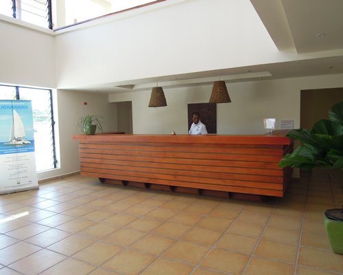 A well furnished reception at the resort with an outside view.