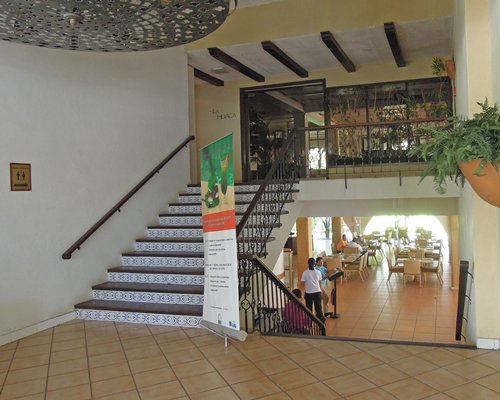Interior view of a restaurant with stairway.