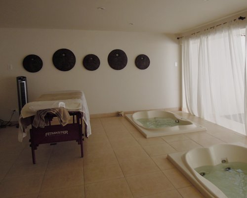 A well furnished indoor spa with bathtubs.