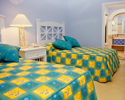 A well furnished bedroom with two beds.