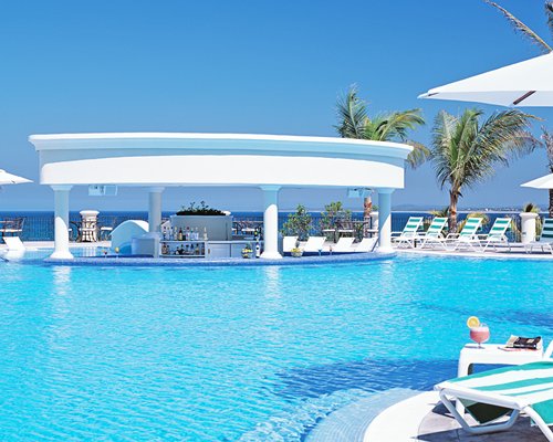 An outdoor swimming pool with a poolside bar.