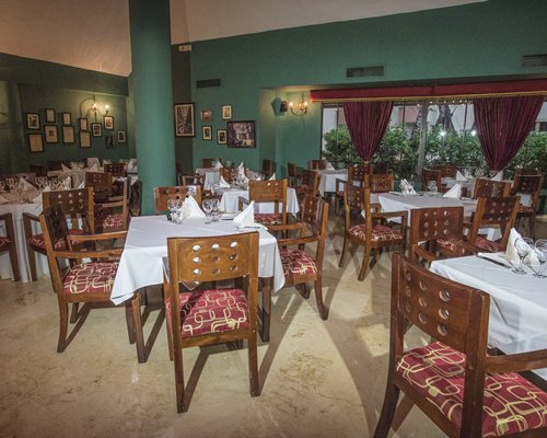 A well furnished indoor fine dining restaurant with an exterior view.