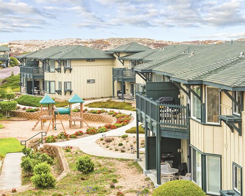An exterior view of the resort with a playscape.