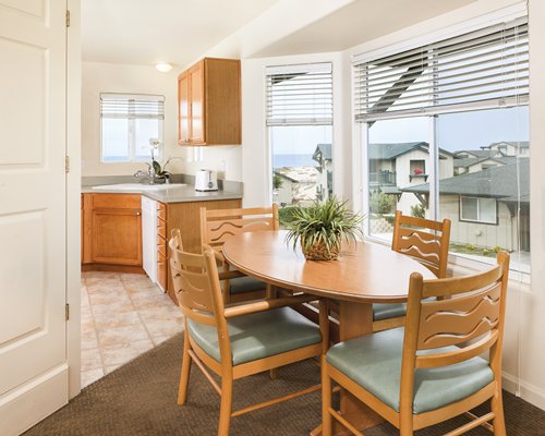 An open plan kitchen and dining area with an outside view.