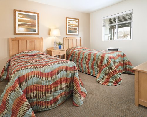 A well furnished bedroom with two twin beds.
