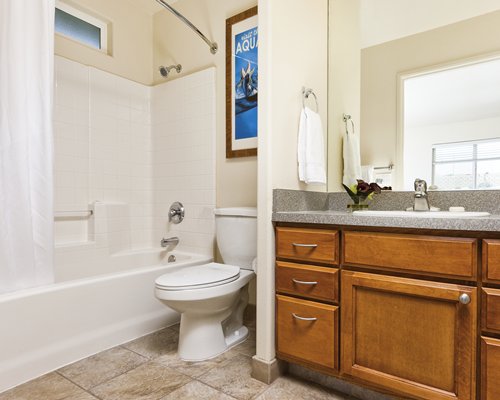 A bathroom with a shower bathtub and single sink vanity.