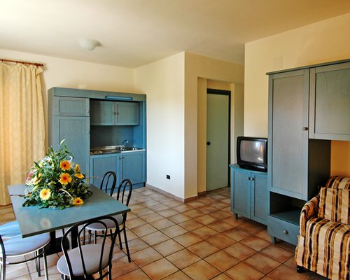 An open plan living and dining area with a television.