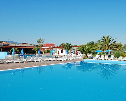 An outdoor swimming pool with chaise lounge chairs.