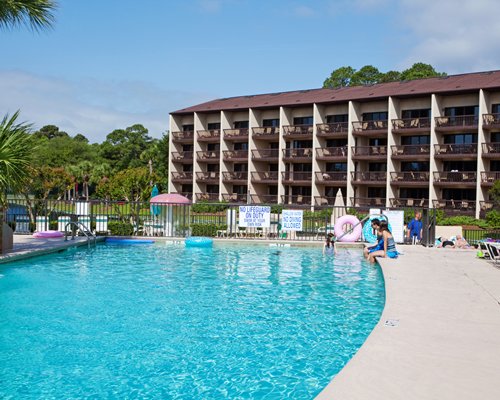 A scenic outdoor swimming pool alongside multi story units.