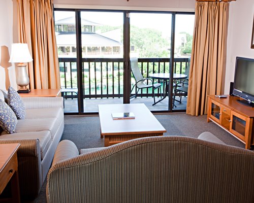 A well furnished living room with a balcony.