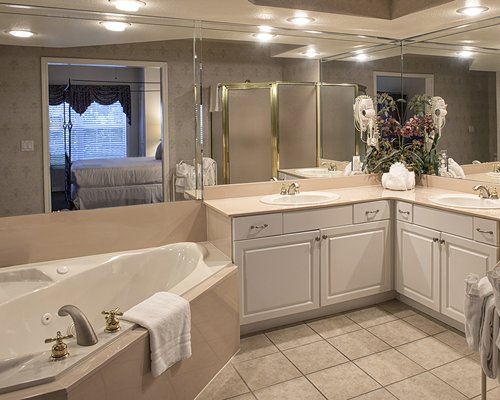 A bathroom with shower bathtub and double sink vanity.