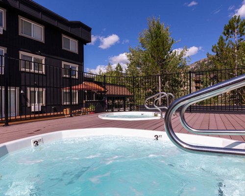 Outdoor hot tub alongside a unit during winter.