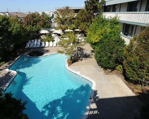 The Beachcomber Condominium Resort with an outdoor swimming pool.