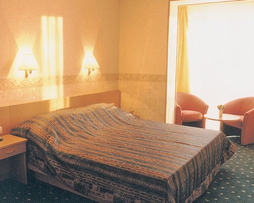 A well furnished bedroom with a double bed and outside view.