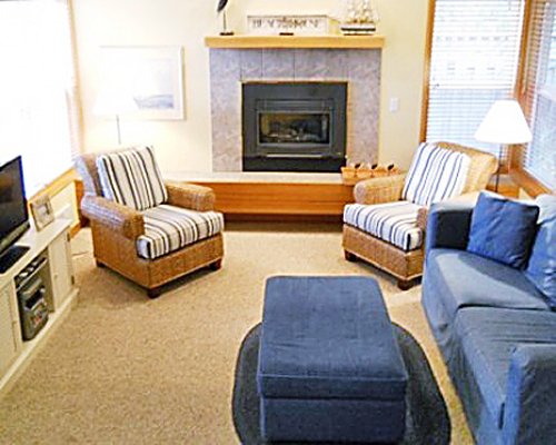 A well furnished living room with a television pull out sofa and a fireplace.
