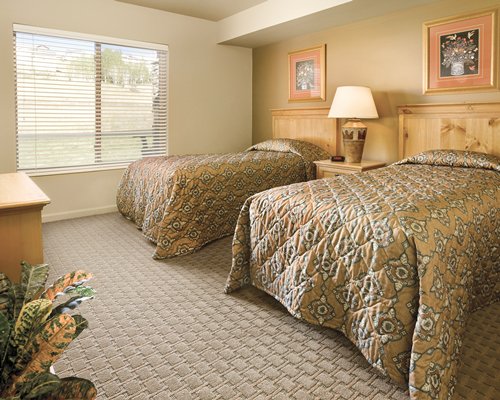 A well furnished bedroom with twin beds and an outside view.