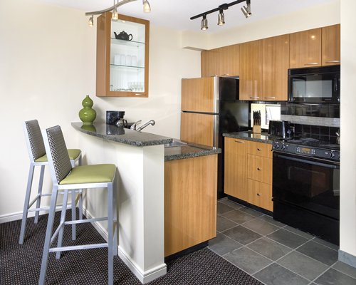 An open plan kitchen with breakfast bar.