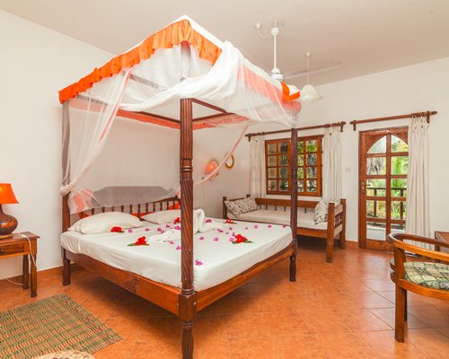 A well furnished bedroom with a double bed and an outside view.