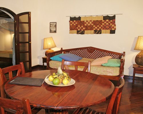 A well furnished dining area alongside a sofa.
