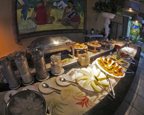 An indoor buffet area with various food items.