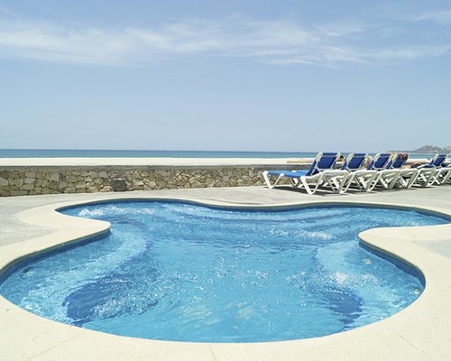Beachfront jacuzzi with lounge chairs