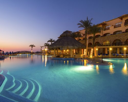 Nighttime view of illuminated resort pool