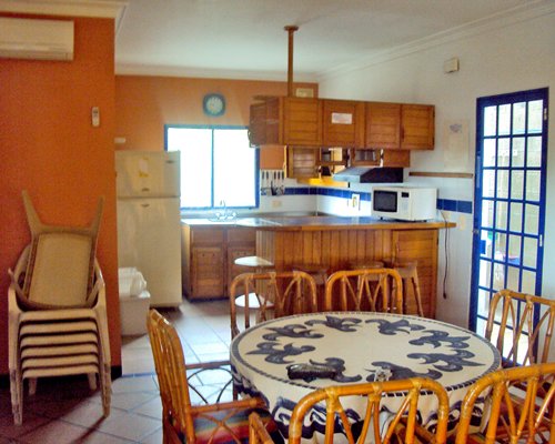 A well equipped kitchen and dining area with a breakfast bar.