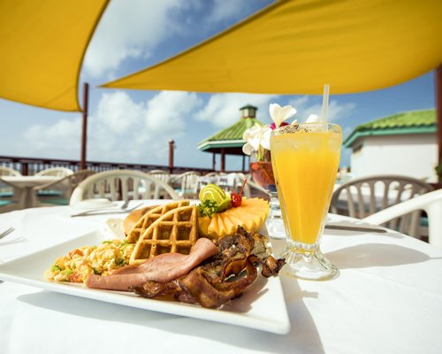 Outdoor restaurant with food item and beverage on the table.