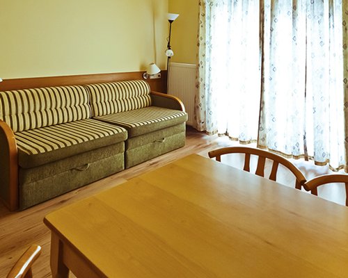 An open plan living and dining area with a double pull out sofa.