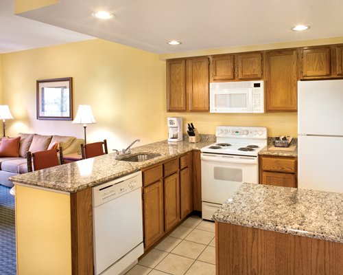 A well equipped kitchen alongside the living area.