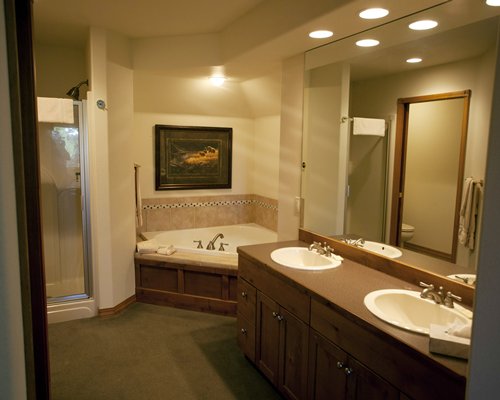 A bathroom with a shower bathtub and double sink vanity.