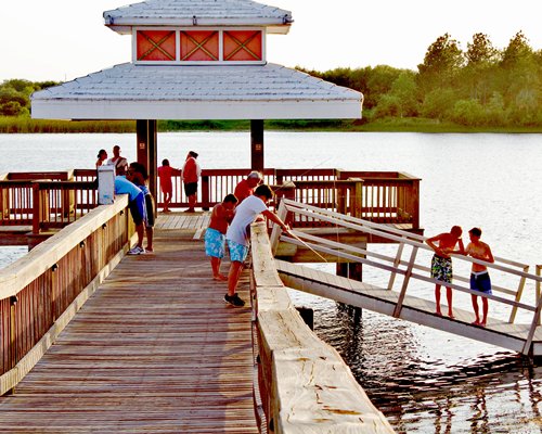 People on a wooden pier at the lake.