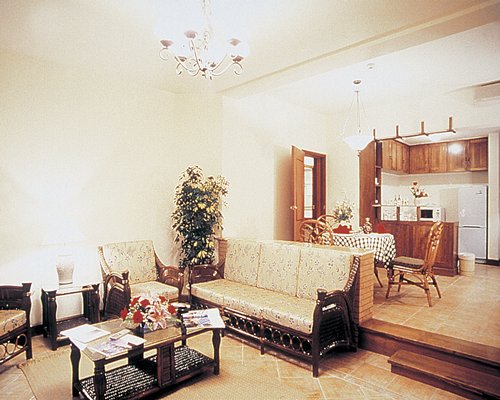 A well furnished living room with dining area and open plan kitchen.