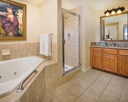 A bathroom with shower bathtub shower stall and closed sink vanity.
