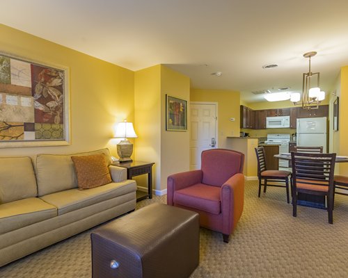 A well furnished bedroom with a king bed and balcony.