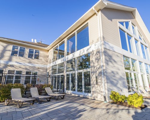 A well furnished living and dining area with a television fireplace and an outside view.